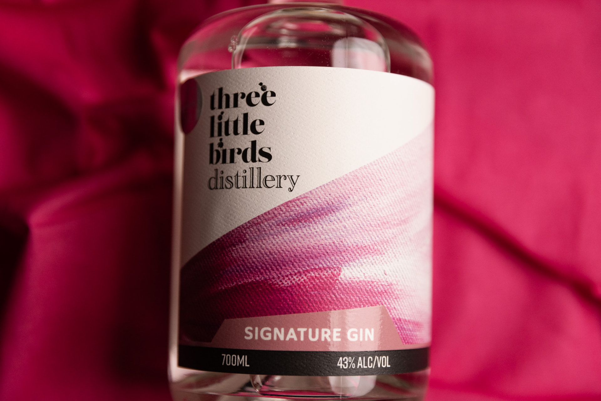 Three Little Birds Signature Gin bottle with its pink label, made in the Clare Valley
